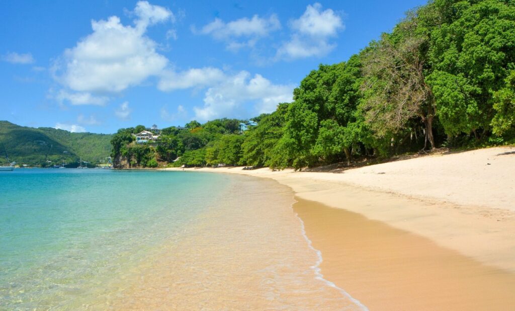 Beautiful sandy beach with turquoise Caribbean waters on Bequia Island in the Grenadines.